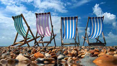 Stripped deckchairs on Brighton Beach