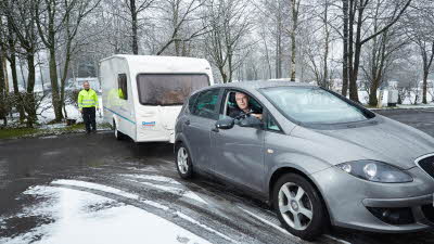 winter caravanning with car towing a caravan on snow